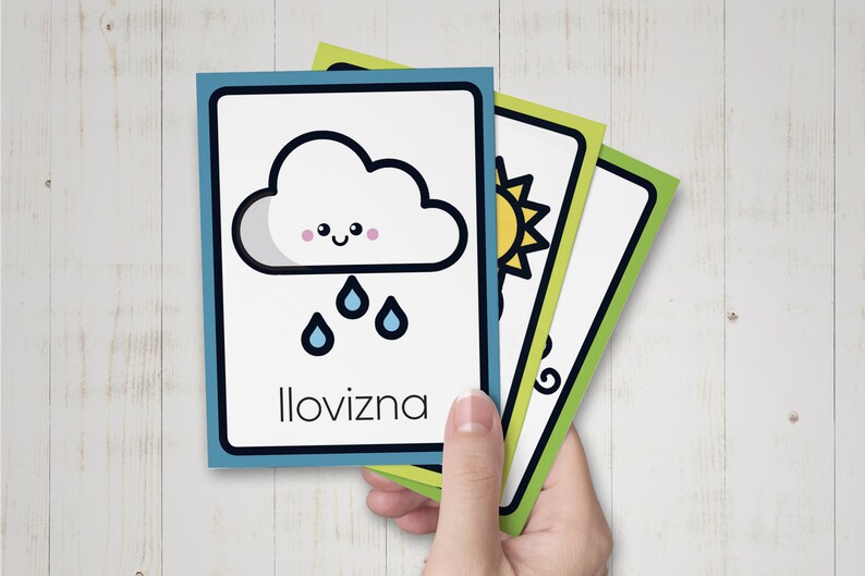 May include: Three illustrated flashcards with a green border. The first card shows a cartoon cloud with raindrops and the word "Ilovizna". The second card shows a cartoon sun. The third card shows a cartoon swirl.