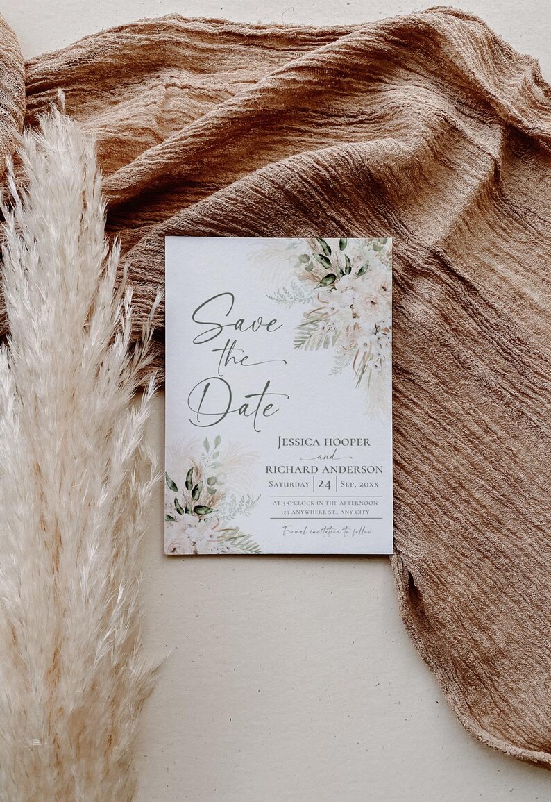 May include: Save the date card with a watercolor floral design. The card features the text "Save the Date" in a cursive font, followed by the names Jessica Hooper and Richard Anderson, the date Saturday, September 24, and the time at 1 o'clock in the afternoon. The card also includes the address 123 Anywhere St, Any City.