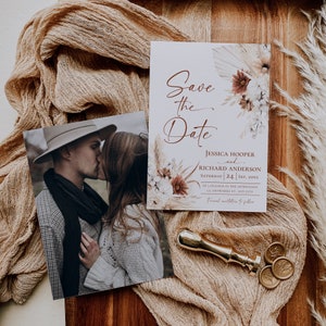 May include: A Save the Date card featuring floral illustrations and the text Jessica Hooper and Richard Anderson, Saturday 24 Sep, 20XX, alongside a photograph of a couple kissing, a gold wax seal stamp, and three round wax seals.