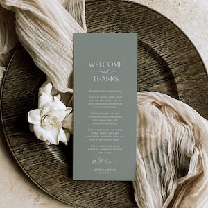 May include: A rectangular sage green welcome and thanks card featuring white serif and script text. The card reads Welcome and Thanks, followed by a message to friends and family, ending with With love, Sophie and David, and the date 10.08.20XX.