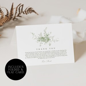 May include: White folded card with a green floral design and the words "THANK YOU". The card also includes the text "INCLUDES FOLDED & FLAT CARD" in a black circle. The card is for a bridal shower.