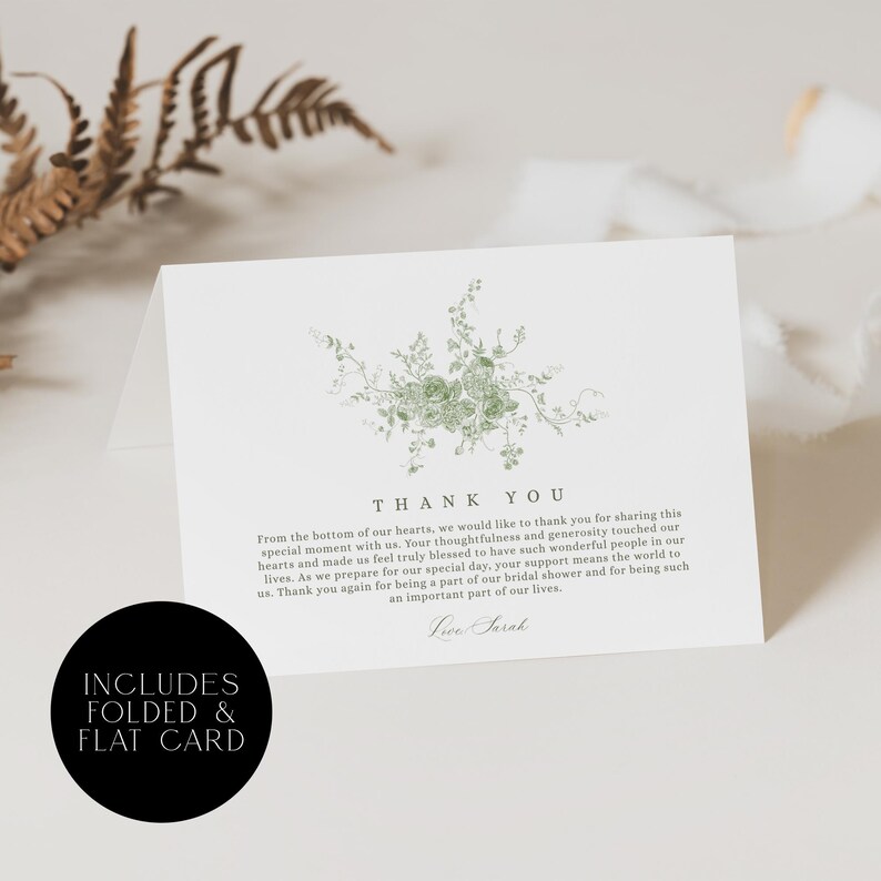 May include: White folded card with a green floral design and the words "THANK YOU". The card also includes the text "INCLUDES FOLDED & FLAT CARD" in a black circle. The card is for a bridal shower.
