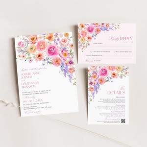 May include: A wedding invitation suite featuring a main invitation, a reply card, and a details card. Each piece is decorated with watercolor floral illustrations in shades of pink, orange, and purple, with printed text in a pink serif font.