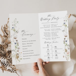 May include: A wedding ceremony program with a floral design. The program includes the order of events for the ceremony and a timeline of the wedding reception. The text includes the names of the wedding party and the officiant.