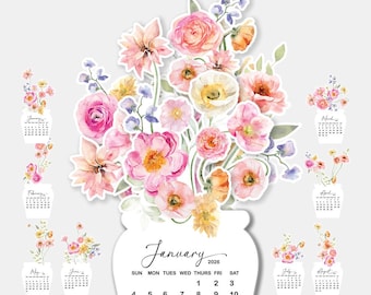 Könnte beinhalten: Ein floraler Schreibtischkalender für 2026 mit Aquarellblumenillustrationen. Das zentrale Design zeigt eine große Vase mit rosa, gelben und orangefarbenen Blumen. Zwölf kleinere Monatskalenderkarten sind um die Mitte angeordnet.