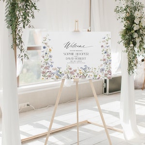 May include: Welcome to our wedding sign with a floral border. The sign features the names Sophie Hooper and David Robert, with the date 08.10.20XX.