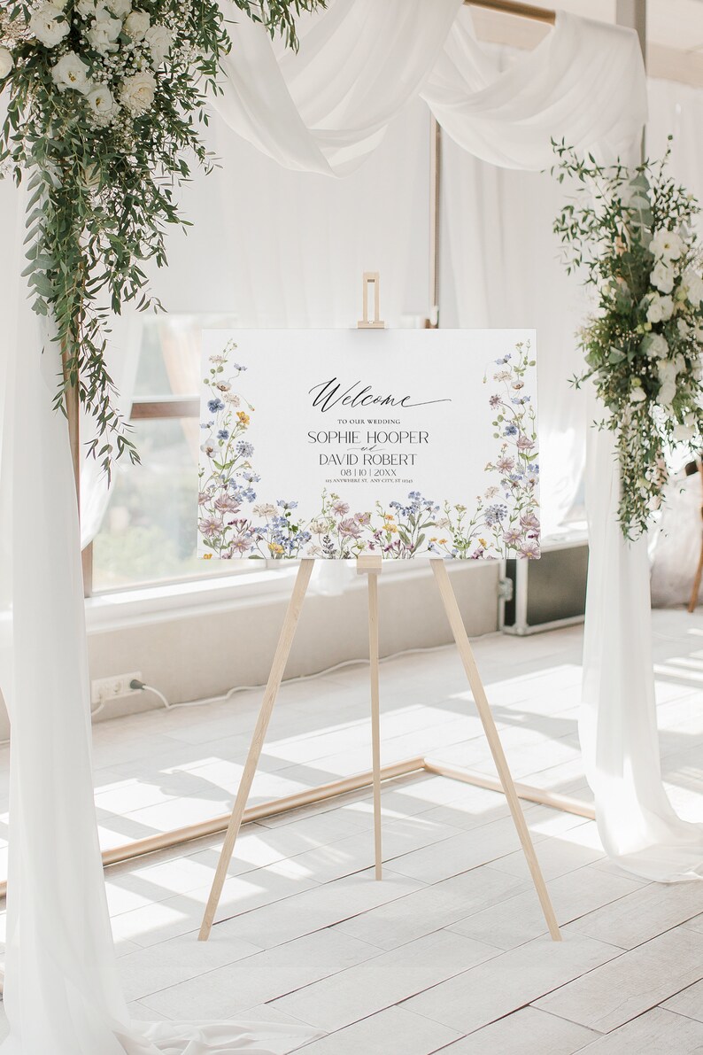 May include: Welcome to our wedding sign with a floral border. The sign features the names Sophie Hooper and David Robert, with the date 08.10.20XX.