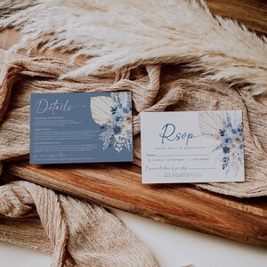 May include: Blue and white wedding RSVP card with a floral design and the text "RSVP Kindly Reply by August 25th". The card includes a section for the guest's name, a choice of attending or not attending, and a space to indicate if they will be staying overnight.
