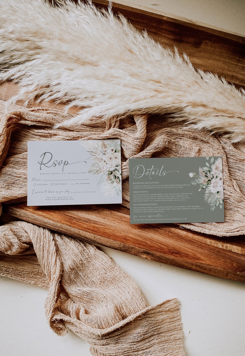 May include: Two rectangular wedding stationery cards featuring floral illustrations. The left card is light gray with the text RSVP, while the right card is sage green with the text Details. Both cards include printed event information.