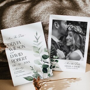 May include: Save the date cards with a watercolor eucalyptus design. The cards feature a black and white photo of a couple and the text "Save the Date Olivia & David Saturday 10.08.20XX".