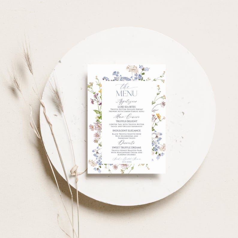 Puede incluir: Un men&uacute; de papel rectangular con un delicado borde floral de acuarela en tonos azules, rosas y amarillos. El texto dice: The Menu, Appetizers, Luxe Sea Bites, Main Course, Truffle Delight, Indulgent Elegance, Desserts, Sweet Truffle Dreams.