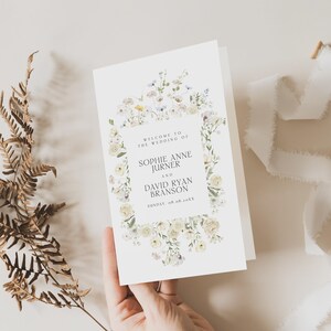 May include: A white wedding invitation with floral border and text. The invitation reads "Welcome to the Wedding of Sophie Anne Jurner and David Ryan Branson, Sunday, 08.08.20XX."