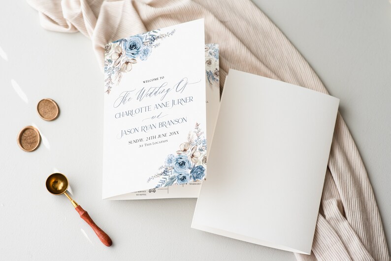 May include: A white wedding program with blue floral designs. The text reads "Welcome to The Wedding of Charlotte Anne Jurner and Jason Ryan Branson Sunday, 24th June 20XX At This Location."