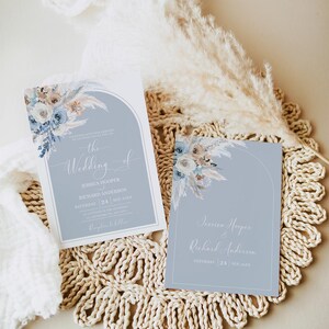 May include: Two wedding invitations with a blue and white floral design. The text on the invitations reads "The Wedding of Jessica Hooper & Richard Anderson" and "Saturday, 24 September".