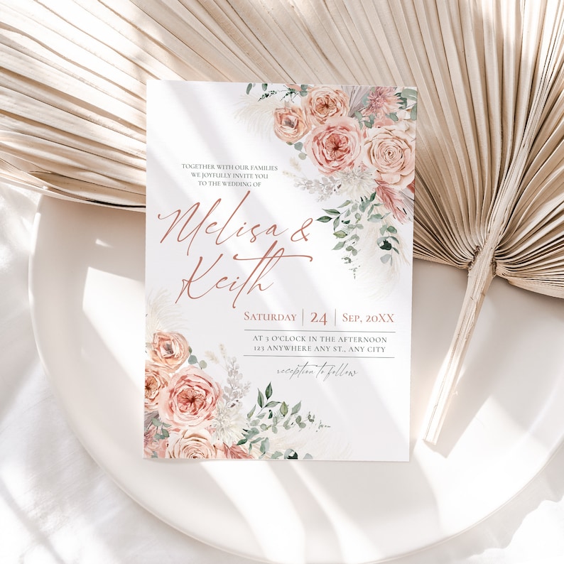 May include: A white wedding invitation card featuring watercolor illustrations of peach roses, pampas grass, and green foliage. The text reads: Together with our families we joyfully invite you to the wedding of Melisa & Keith, Saturday 24 Sep, 20XX.