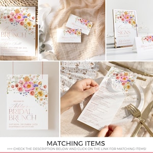 May include: A collection of bridal brunch stationery featuring white paper with watercolor floral arrangements in pink, yellow, and purple. The items include invitations, menu cards, and signage with rose gold text detailing event information.