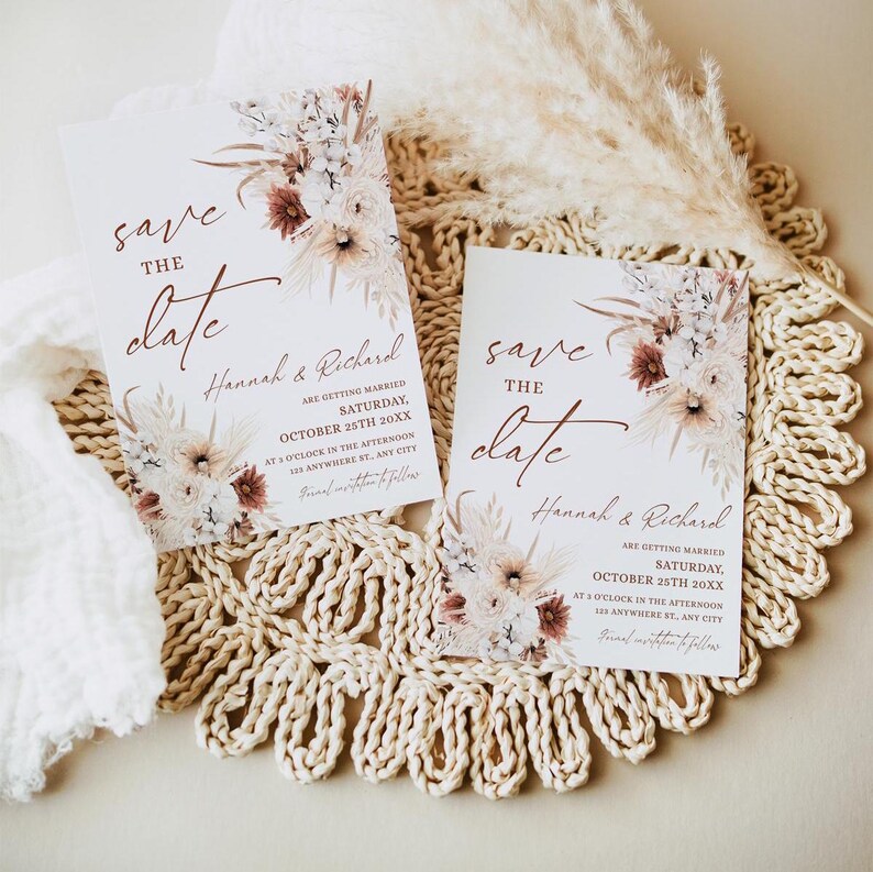 May include: Two save the date cards with a floral design and the text "save the date" in cursive. The cards are on a woven placemat. The text on the cards reads "Hannah & Richard are getting married Saturday, October 25th 20XX at 8 o'clock in the afternoon anywhere SE, any city."