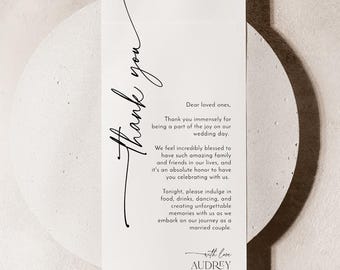 May include: A vertical white wedding thank you card featuring black text. The script reads Thank you, followed by a message to loved ones, and concludes with the names Audrey and James and the date 08.27.20XX in a clean serif font.