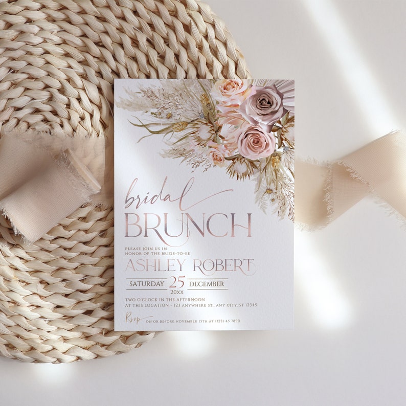 May include: A blush pink and white floral bridal brunch invitation with a gold foil script font. The invitation reads "bridal brunch" and includes the bride-to-be's name, the date, and RSVP information.