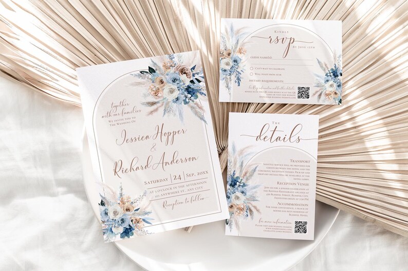 May include: A wedding invitation suite featuring a main invitation, an RSVP card, and a details card. Each white card displays an arched frame, blue and beige floral arrangements, and elegant script text including names and event details.