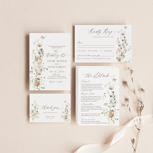 May include: Wedding invitation suite with a floral design featuring white and blue flowers. The invitation includes the text "The Wedding of Sophie Hooper and David Robert" and the date "08.10.20XX". The RSVP card includes a floral design and the text "Kindly RSVP by August 25th". The details card includes a floral design and the text "The Details".