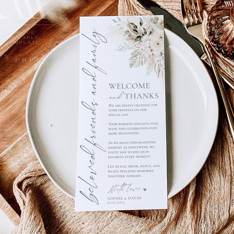 May include: A rectangular white wedding thank you card featuring a floral illustration of pampas grass and dried leaves at the top. The text reads: Beloved friends and family, Welcome and Thanks, We are deeply grateful for your presence on our special day. Sophie & David 10.08.20XX.
