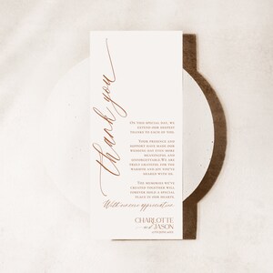 May include: A rectangular white wedding thank you card with copper-coloured text. The card features the words Thank you in large script, followed by a message of gratitude and the names Charlotte and Jason with the date 27th June 20XX.