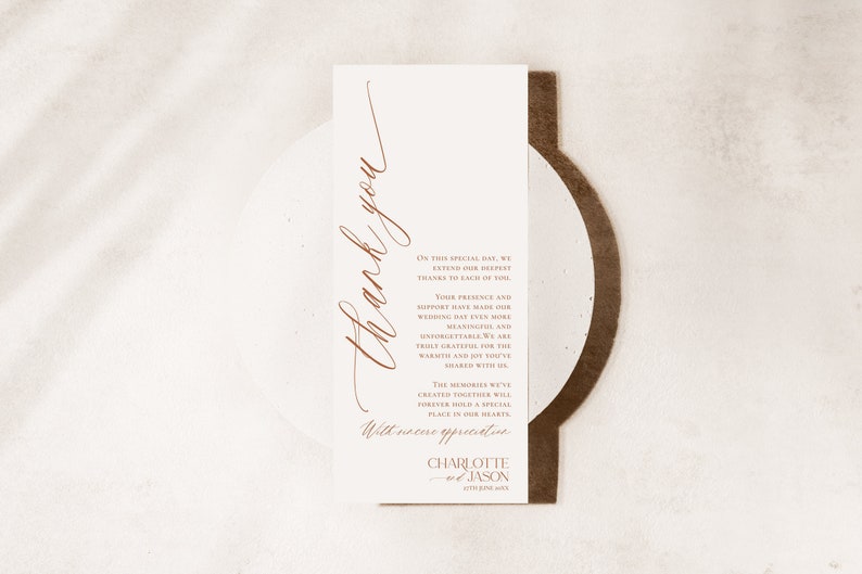 May include: A rectangular white wedding thank you card with copper-coloured text. The card features the words Thank you in large script, followed by a message of gratitude and the names Charlotte and Jason with the date 27th June 20XX.