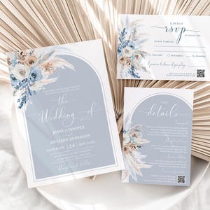 May include: A wedding invitation suite with a blue and white floral design. The invitation features a watercolor illustration of pampas grass and flowers. The text reads "The Wedding of Jessica Hooper and Richard Anderson, Saturday, 24th of June".