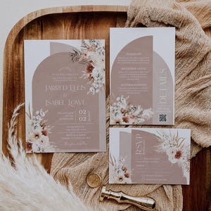 May include: A wedding invitation suite with a brown and white floral design. The invitation features the names "Jarred Ellis & Isabel Lowe" and the date "02.02.2022". The RSVP card includes a QR code.