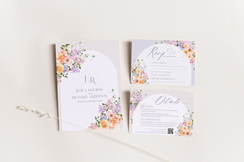 May include: A set of wedding invitation cards with a floral design. The cards are white with a light purple background and feature a watercolor illustration of pink, orange, and purple flowers. The text on the cards reads "Jessica Hooper and Richard Anderson, Sunday, 14th July 2024".