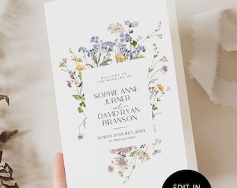 May include: A white wedding invitation with floral accents in blue, yellow, and purple. The text reads "Welcome to the Wedding of Sophie Anne Jurner and David Ryan Branson, Sunday 27th July, 20XX at this location." The invitation is edited in Canva.