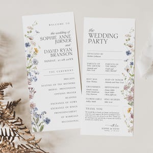 May include: Two white wedding program cards featuring watercolor wildflower illustrations in blue, yellow, and purple. The text details the ceremony order, wedding party names, and a thank you note for Sophie Anne Jurner and David Ryan Branson.