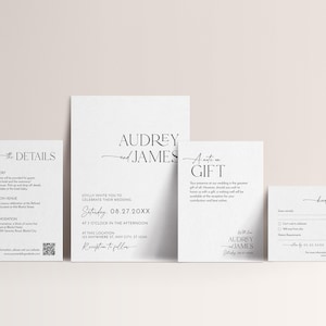 May include: A set of elegant white wedding stationery with black text. The set includes an invitation, details card, gift card, and RSVP card. The invitation features the names "Audrey and James" in a stylish font.