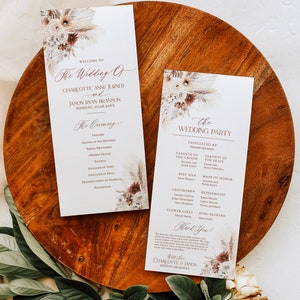 May include: A wedding ceremony programme with a floral design featuring dried flowers and pampas grass. The programme includes the order of events for the ceremony and the wedding party. The text includes the names Charlotte Anne Jurner and Jason Ryan Branson, the date 07.08.20XX, and the words "The Wedding Of" and "The Ceremony".