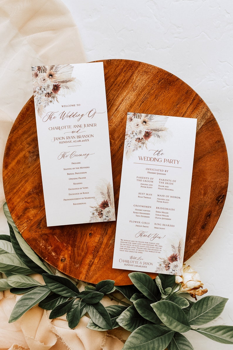 May include: A wedding ceremony programme with a floral design featuring dried flowers and pampas grass. The programme includes the order of events for the ceremony and the wedding party. The text includes the names Charlotte Anne Jurner and Jason Ryan Branson, the date 07.08.20XX, and the words "The Wedding Of" and "The Ceremony".