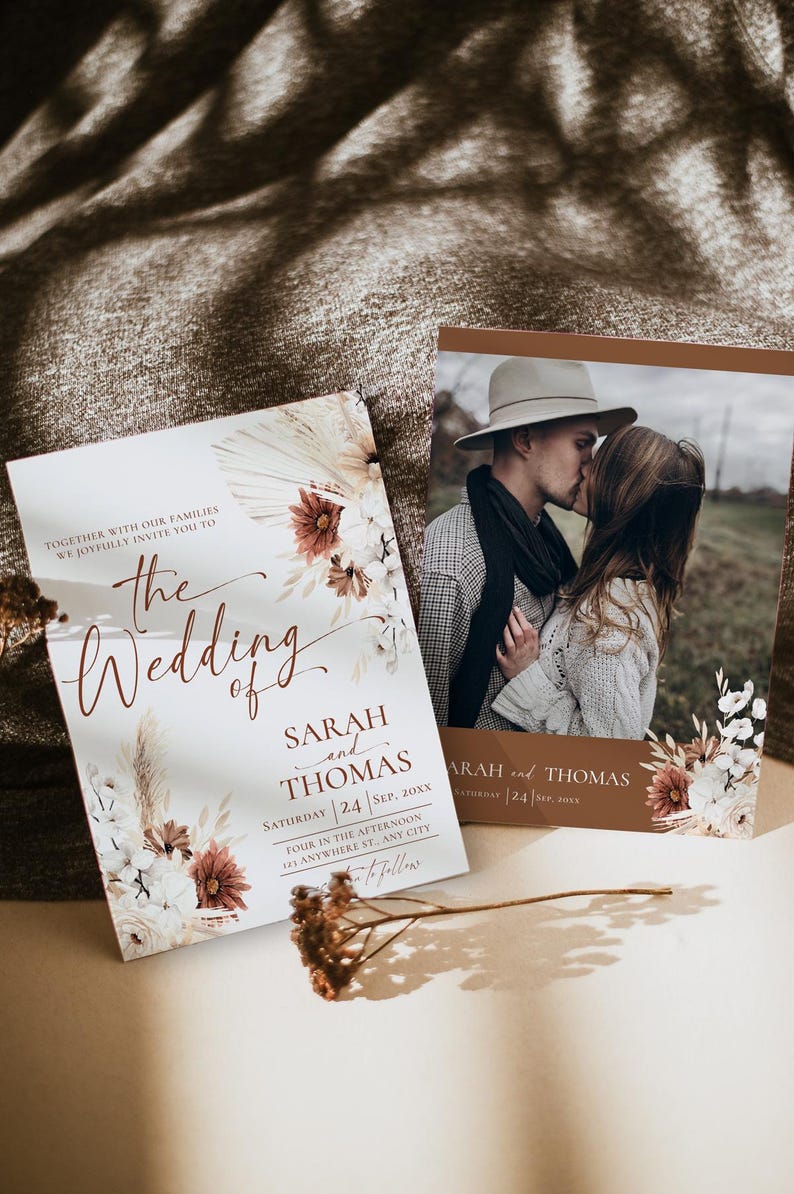 May include: Two rectangular wedding invitation cards featuring a photograph of a couple kissing, dried floral illustrations in shades of brown and cream, and printed text including the names Sarah and Thomas and the date September 24, 20XX.