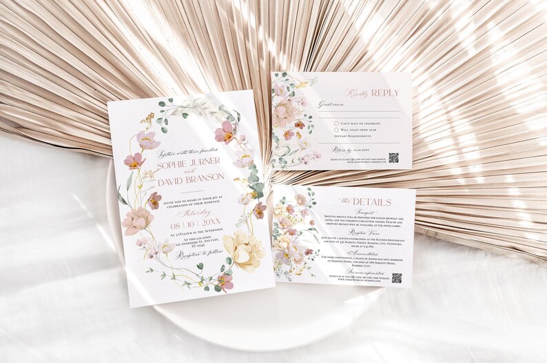 May include: Wedding invitation suite with floral design. The invitation features a watercolor illustration of pink and yellow flowers with green leaves. The text reads "Together with their families, Sophie Jurine and David Branson, Saturday, 08.10.20XX, at a location in the Arboretum, Reception to follow."