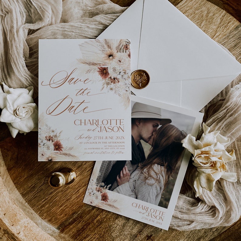 May include: Save the date card featuring a floral design and a photograph of a couple kissing. The card reads "Save the Date" in cursive script and "Charlotte and Jason" in a serif font. The date is 27th July 202X.