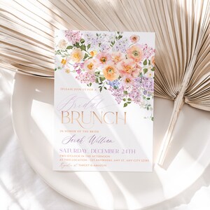 May include: A floral-themed bridal brunch invitation with a watercolor design of pink and purple flowers. The text reads "Please join us for a Bridal Brunch in honor of the bride Sarah William Saturday, December 24th Two o'clock in the afternoon at this location - 123 Anywhere, Any St. Any City 12345  Registers at Target & Amazon"