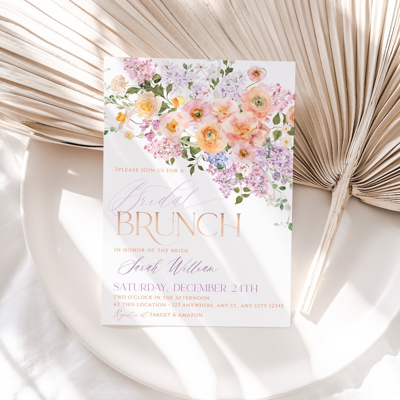 May include: A floral-themed bridal brunch invitation with a watercolor design of pink and purple flowers. The text reads "Please join us for a Bridal Brunch in honor of the bride Sarah William Saturday, December 24th Two o'clock in the afternoon at this location - 123 Anywhere, Any St. Any City 12345  Registers at Target & Amazon"