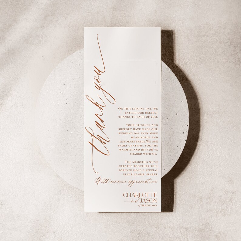 May include: A vertical white wedding thank you card featuring copper-coloured text. The card displays the words Thank you in large script, followed by a message of gratitude, the names Charlotte and Jason, and the date 27th June 20XX.