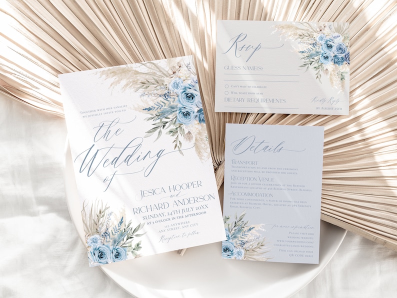 May include: A wedding invitation suite with a blue and white floral design. The invitation features the text "the wedding of Jesica Hooper and Richard Anderson" with the date "Sunday, 24th July 20XX". The RSVP card includes the text "RSVP" and "Guess Names". The details card includes the text "Details" and "Transport".
