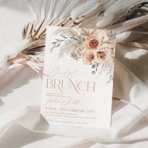 May include: A rectangular invitation card featuring a watercolor floral arrangement of roses and pampas grass at the top. The text reads Bridal BRUNCH, PLEASE JOIN US IN HONOR OF THE BRIDE-TO-BE, Julia Smith, SUNDAY, 25TH FEBRUARY 20XX, and RSVP details.