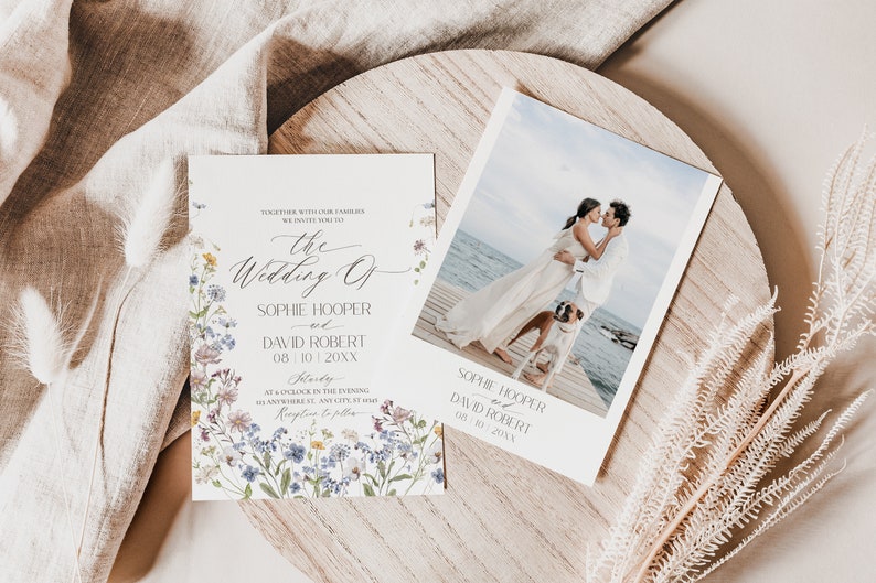 May include: A wedding invitation set featuring a floral-bordered card with text reading The Wedding of Sophie Hooper and David Robert, and a photo card showing a couple and a dog on a wooden pier with the names and date printed below.