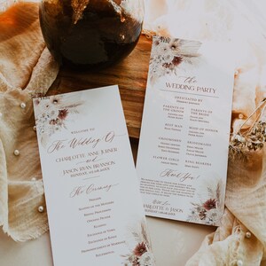 May include: A wedding ceremony order of service and wedding party information card with a floral design. The order of service includes the order of events for the ceremony, including the prelude, seating of the mothers, bridal procession, opening prayer, reading, exchange of vows, exchange of rings, pronouncement of marriage, and recessional. The wedding party card lists the officiant, parents of the bride and groom, best man, groomsmen, maid of honour, bridesmaids, flower girls, and ring bearers.