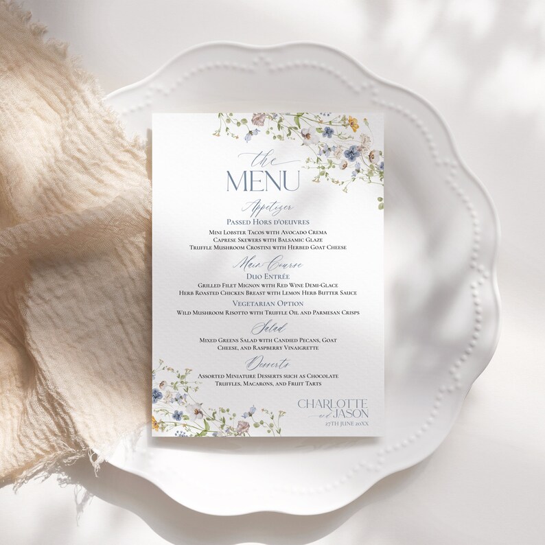 May include: A floral wedding menu with a blue and white floral design. The menu includes appetizers, main course, salad, and desserts. The text at the bottom of the menu reads "Charlotte & Jason 27th June 20XX".