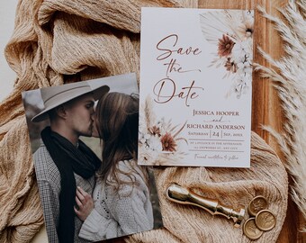 May include: A Save the Date card featuring floral illustrations and the text Jessica Hooper and Richard Anderson, Saturday 24 Sep, 20XX, alongside a photograph of a couple kissing, a gold wax seal stamp, and three round wax seals.