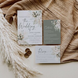 May include: A wedding invitation suite featuring a main invitation, a details card, and an RSVP card, all decorated with watercolor floral and pampas grass illustrations. Three gold wax seals are included alongside the stationery set.