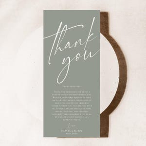 May include: A rectangular sage green thank you card featuring white script text that reads Thank you followed by a message to loved ones and the names Olivia and Robin with the date 10.11.20XX printed in a clean serif font.